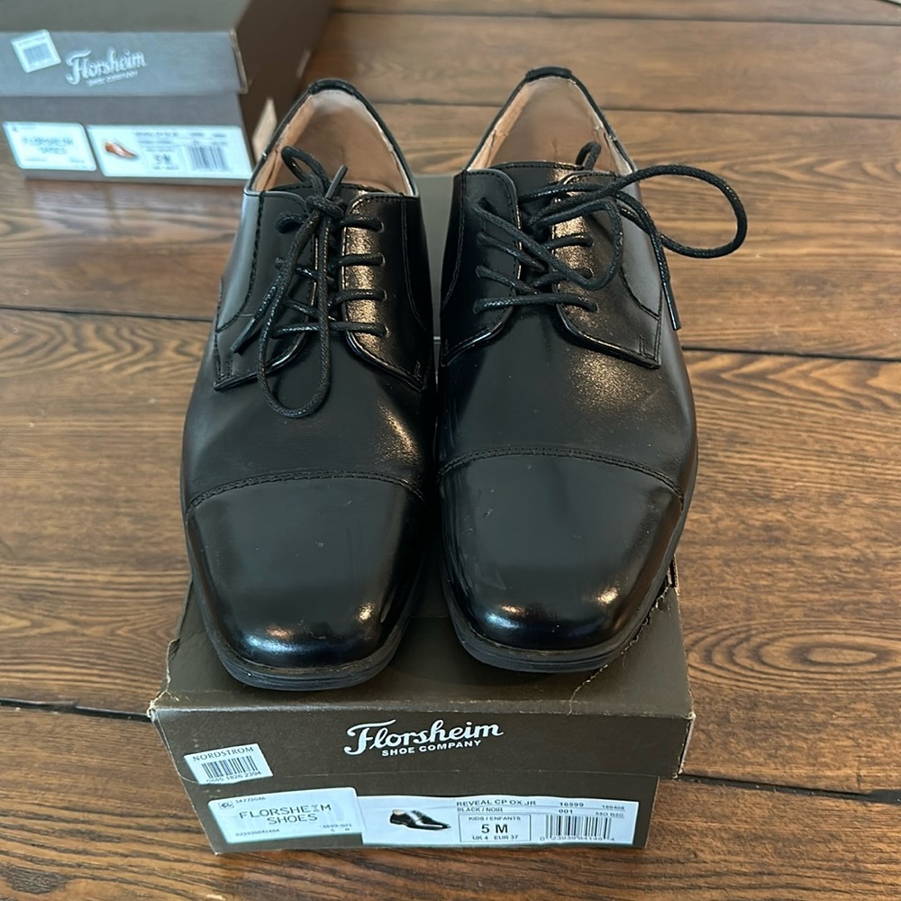 Boys size 5 dress shoes by Florsheim in black.